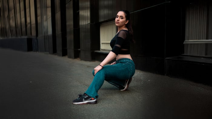 Model posing in black top and jeans