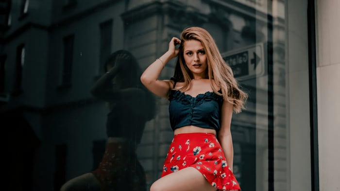 Girl in black top and red skirt posing
