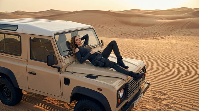 Woman lying on a jeep in the desert