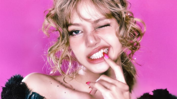 Lisa from BLACKPINK winks and smiles