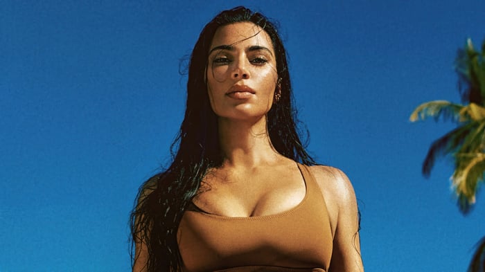 Kim Kardashian in a brown bikini against a blue sky