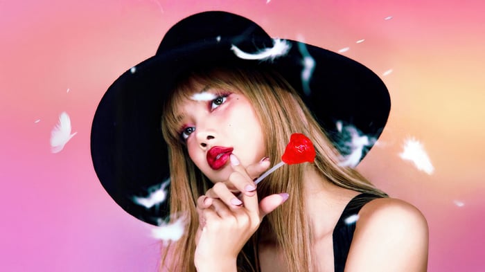 Lisa from BLACKPINK with a heart lollipop