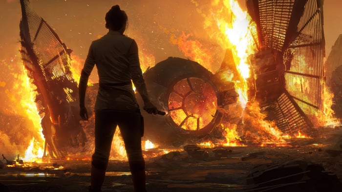 Rey in front of burning TIE Fighter 4K