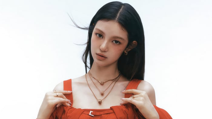 Danielle from NewJeans wearing red dress and jewelry