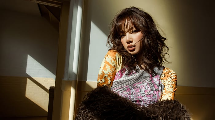 Lisa from BLACKPINK in a patterned top and fur coat