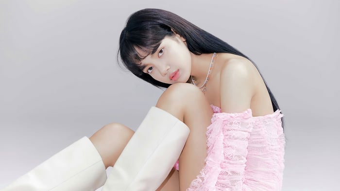 Lisa from BLACKPINK in pink dress and white boots