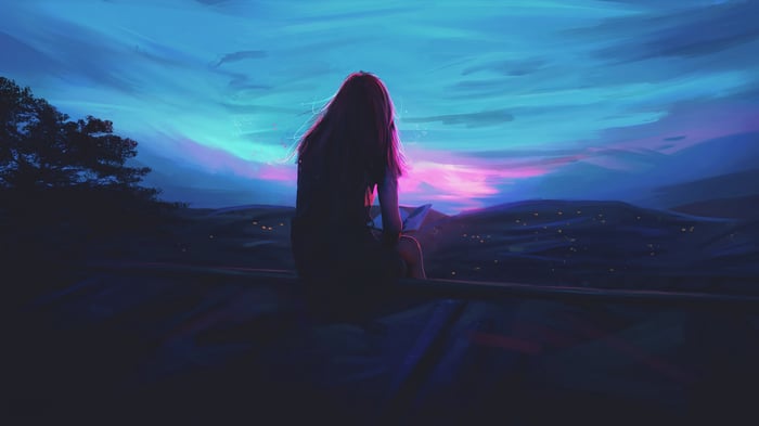 Girl sitting and looking at the sunset 4K