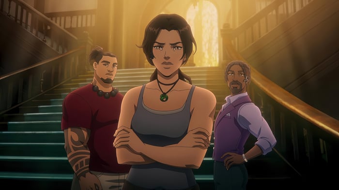 Lara Croft and companions in a grand staircase
