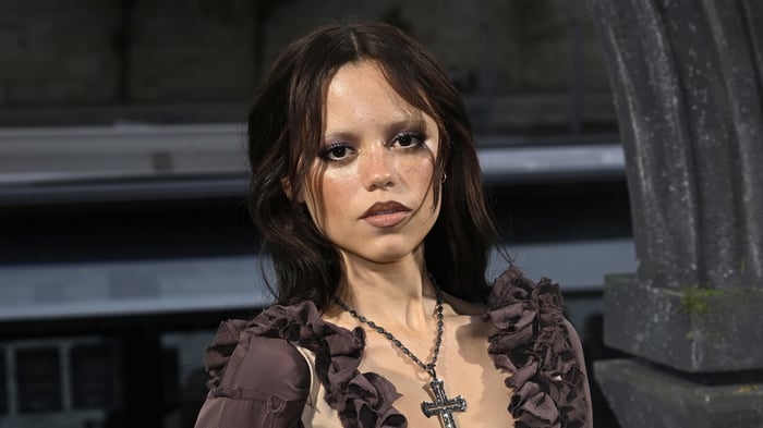 Jenna Ortega in gothic attire with cross necklace
