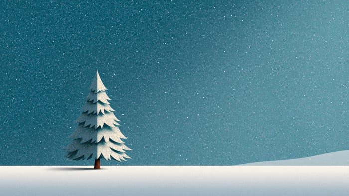 A lone snow-covered Christmas tree under a starry sky