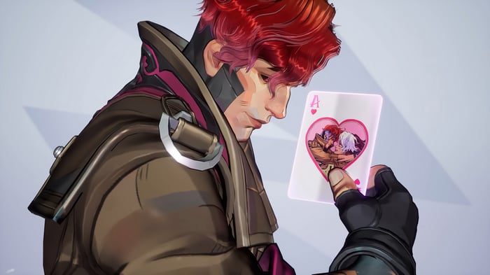 Gambit holding an Ace of Hearts card with a couple kissing