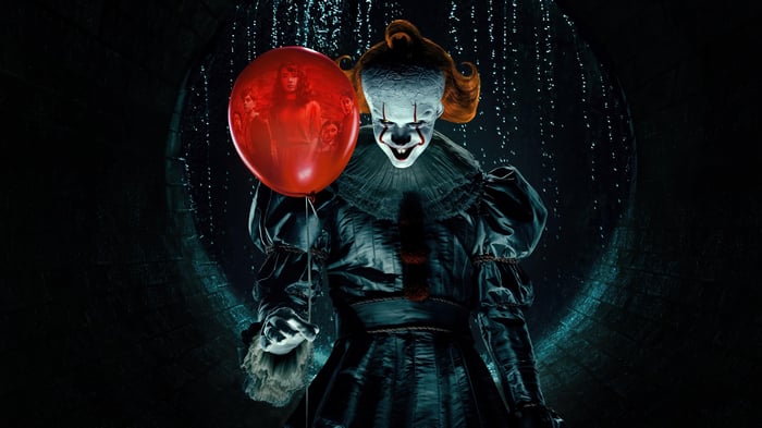 Pennywise the Clown holding a red balloon