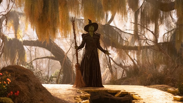 Elphaba from Wicked holding a broomstick