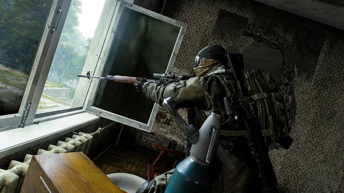 Soldier aiming rifle through broken window in 4K
