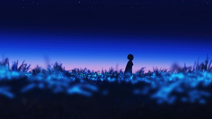 Silhouette of a girl in a field of glowing flowers at night