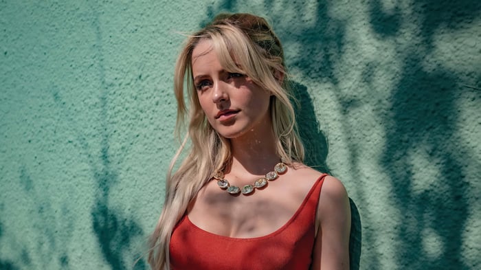 Mckenna Grace in a red dress with a necklace