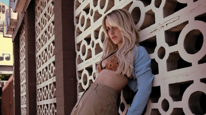 Mckenna Grace poses against a decorative wall