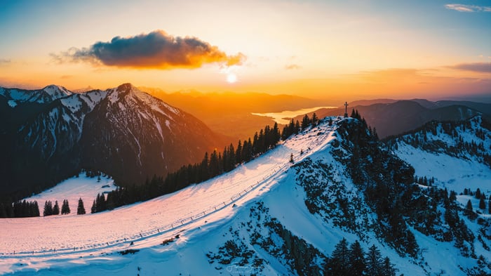 Sunrise over snowy mountains with a lake