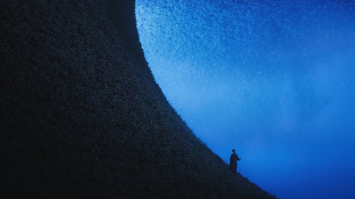 Silhouette on a dark hill under a starry blue sky 4K
