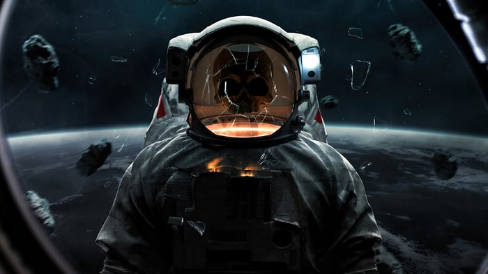 Astronaut with cracked helmet and skull reflection in space