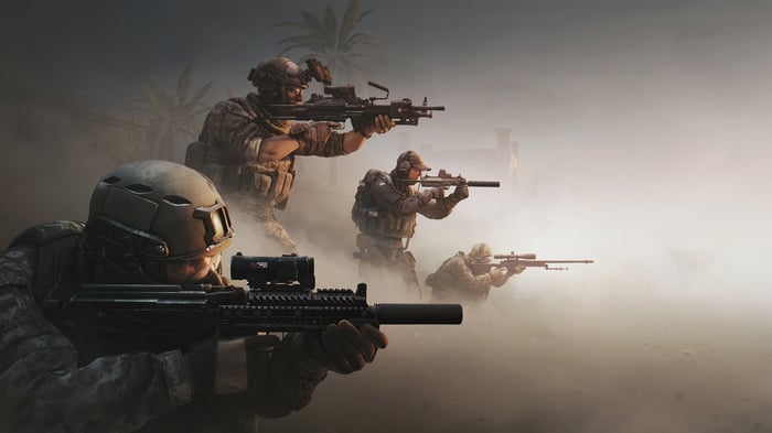 Soldiers in a dusty environment with rifles