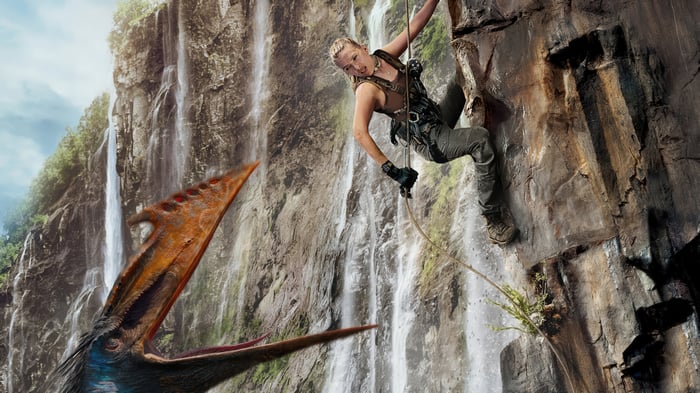 Woman climbing cliff near Pteranodon in Jurassic World Rebirth 4K