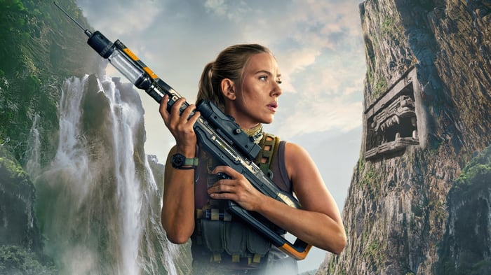 Scarlett Johansson with futuristic rifle in jungle