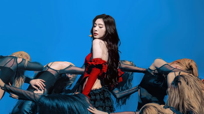 Irene and dancers in red and black outfits