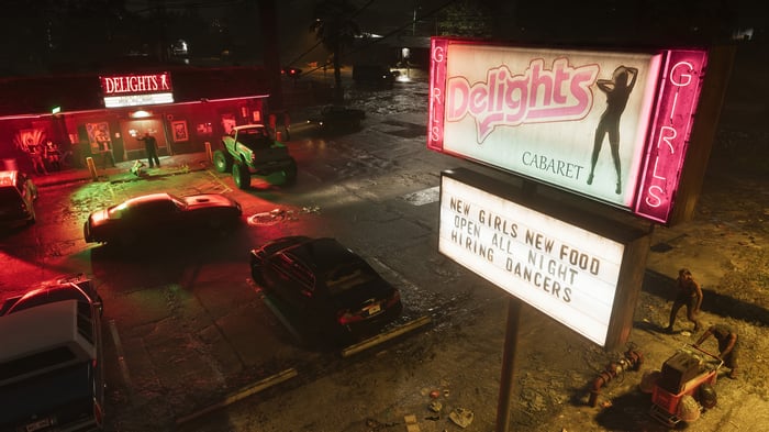Delights Cabaret sign with cars and people at night
