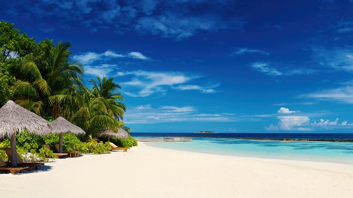 Maldives Tropical Beach with Palm Trees and Umbrellas