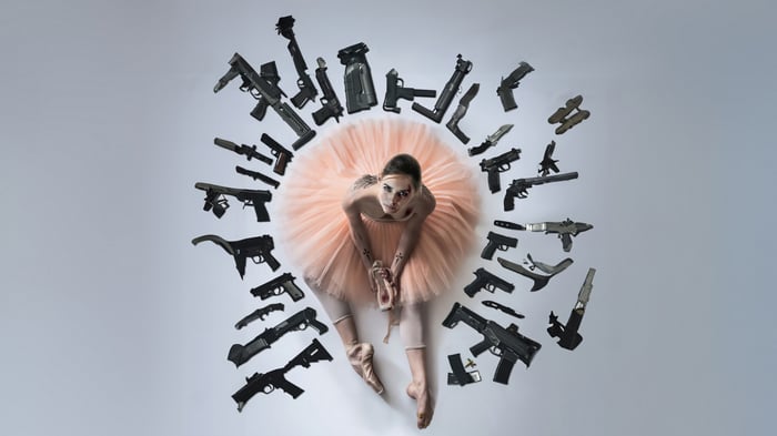Ballerina surrounded by guns