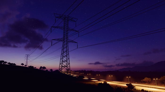 Night sky with power lines and highway