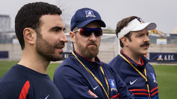 Ted Lasso and coaches on a field