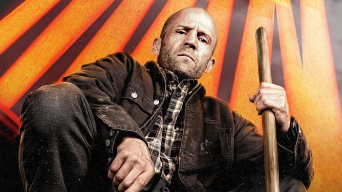 Jason Statham Holding a Wooden Stick