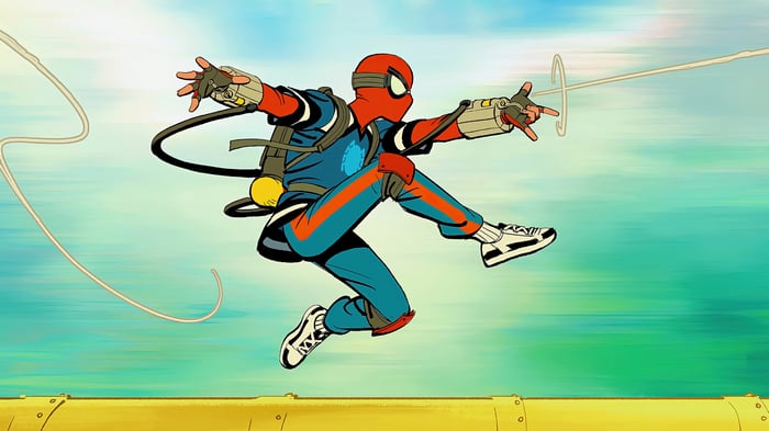 Spider-Man in a blue and orange suit swings with webs
