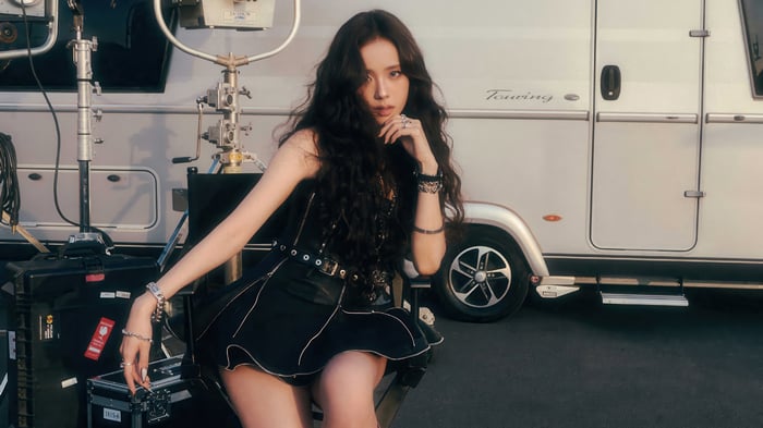 Jisoo in black outfit with RV and equipment