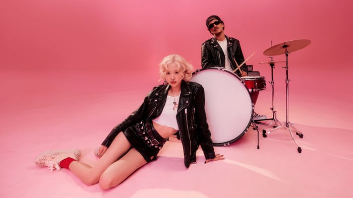 Rose and drummer in a studio with pink background