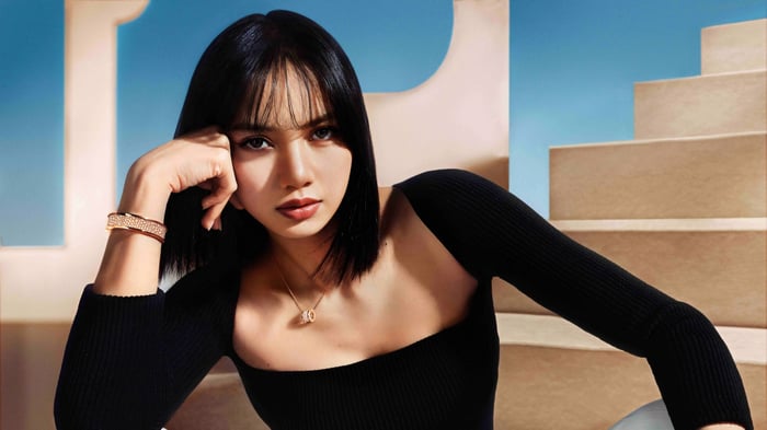 Lisa from BLACKPINK wearing a black top and jewelry