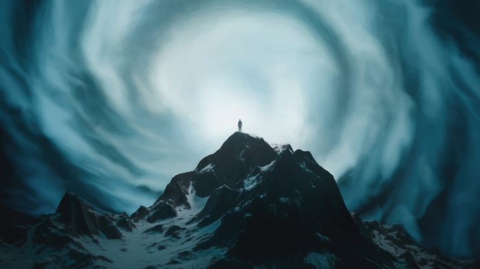 Man on Mountain Summit Under Swirling Sky 4K