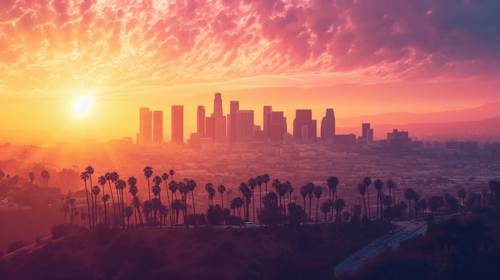 Los Angeles skyline at sunset with palm trees