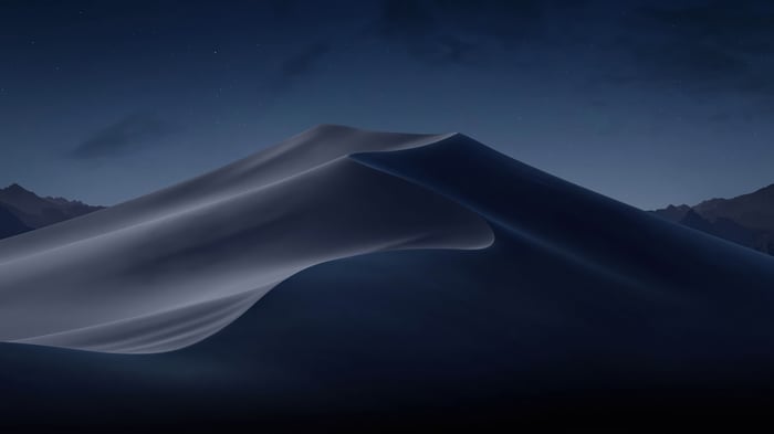 Desert dunes at night under a starry sky
