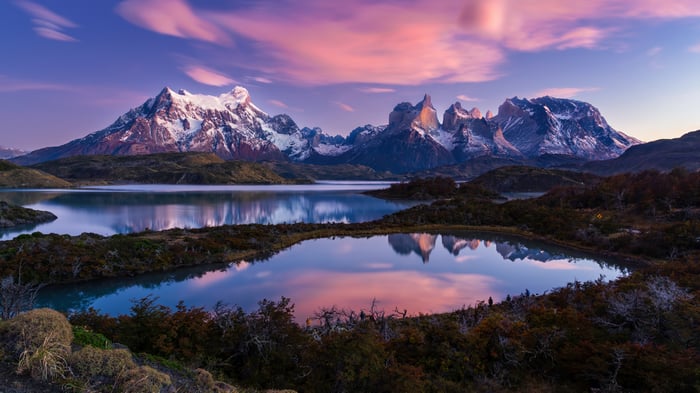 Snowy Mountains Reflecting in a Lake at Sunset