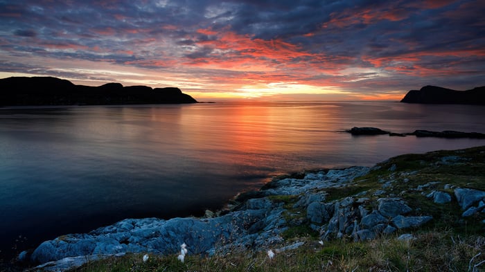 Sunset over the sea with rocky shore 4K