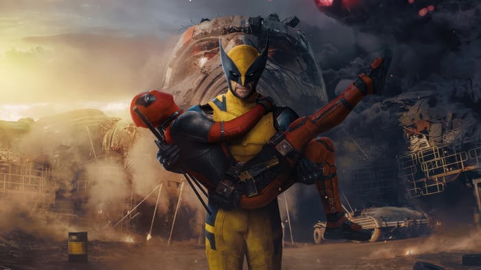 Wolverine Carrying Deadpool in a Ruined Landscape 4K