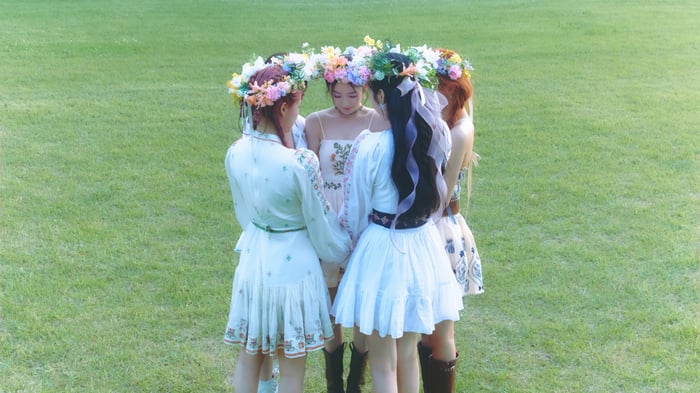Red Velvet girls in flower crowns on grass
