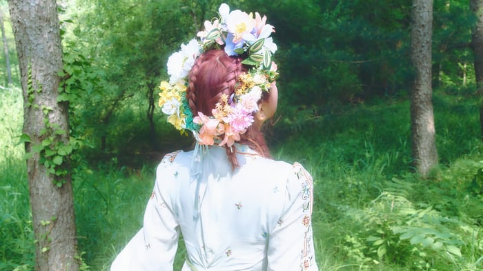 Red Velvet Yeri in a forest with a flower crown