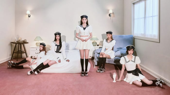 Red Velvet members in sailor outfits in a room