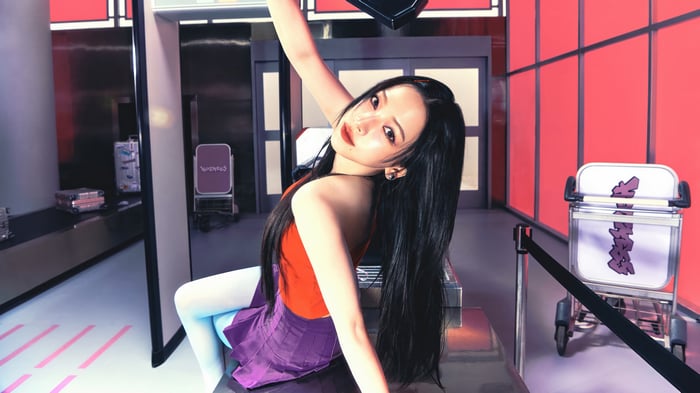 Karina from Aespa in a red top and purple skirt