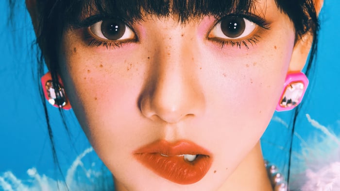 Karina from Aespa with pink makeup and freckles