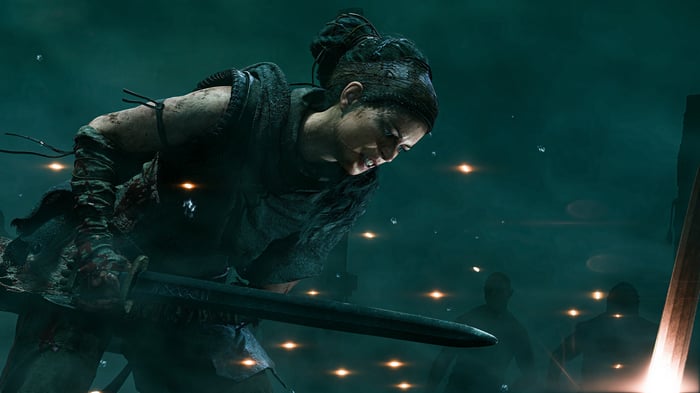 Woman with sword in a dark, misty environment
